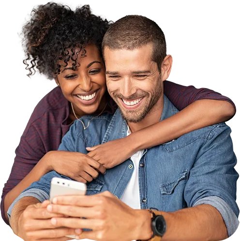 A couple smiling at a phone together